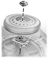 4. Remove the wing nut securing the spare tire by turning it counterclockwise.